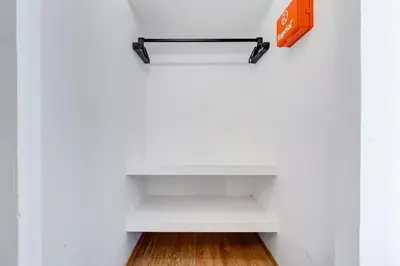 a white shelf in a white wall with an orange box at Salotto San Pietro in Rome