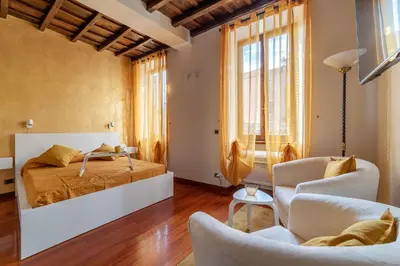 a bedroom with a bed and a living room at GuestHost - Trastevere Leopard'Oro Apartment in Rome