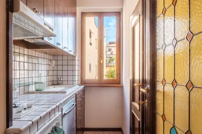 a kitchen with a sink and a window at GuestHost - Trastevere Leopard'Oro Apartment in Rome