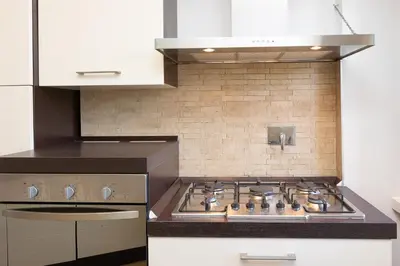 a kitchen with a stove top oven in a kitchen at Piramide view by Rental in Rome in Rome