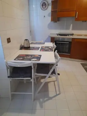 a kitchen with a stove and a white counter top at Allegra’s House Barberini in Rome