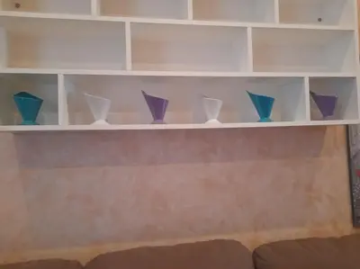 a shelf with purple and blue vases on it at Allegra’s House Barberini in Rome