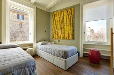 a bedroom with two beds and two windows at Casa Loren con Terrazzo in Rome