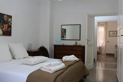 a bedroom with a bed with towels on it at Casa di Pera in Rome