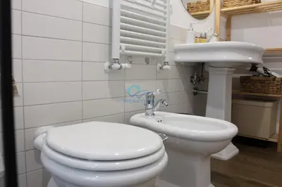 a bathroom with a toilet and a sink at Casa di Pera in Rome