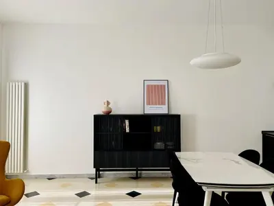 a living room with a table and a white wall at GuestHost - The Design Pasta Apartment in Rome