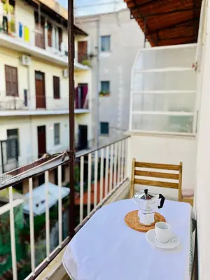a table with a cup of coffee on a balcony at GuestHost - The Design Pasta Apartment in Rome