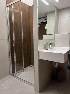a bathroom with a sink and a shower at LEMON SUITES APARTMENTS in Rome