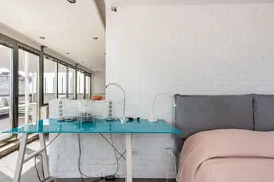 a bedroom with a blue table next to a bed at Trastevere Attic Raffaello’s rooms in Rome