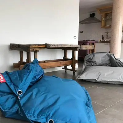 a blue tent sitting on the floor next to a table at Trastevere Attic Raffaello’s rooms in Rome
