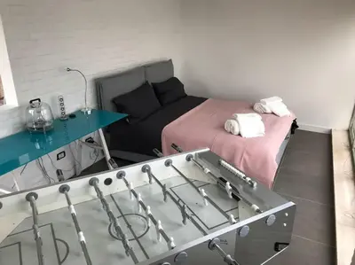 a room with a bed and a table and a couch at Trastevere Attic Raffaello’s rooms in Rome