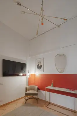 a living room with a chair and a table at Boho Chic Apartment By Nosdom Properties in Rome
