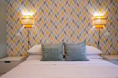 a bedroom with a bed with two lamps on it at Arezzo 38 in Rome
