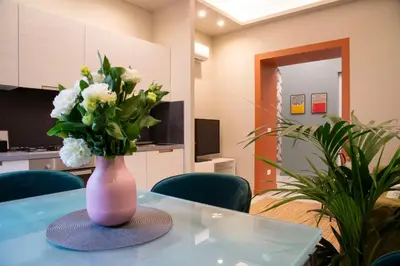 a pink vase with white flowers on a table at Arezzo 38 in Rome