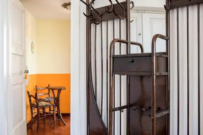 a room with a wooden table and a chair at Vittoria in Trastevere Apartment in Rome