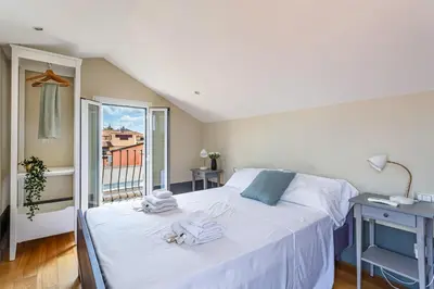a bedroom with a bed with towels on it at iFlat Magical flat by the Tiber in Rome