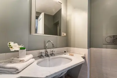 a bathroom with a sink and a mirror at iFlat Magical flat by the Tiber in Rome