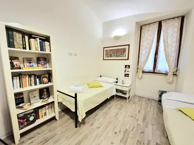 a bedroom with a bed and a book shelf at MusicArt House in Rome