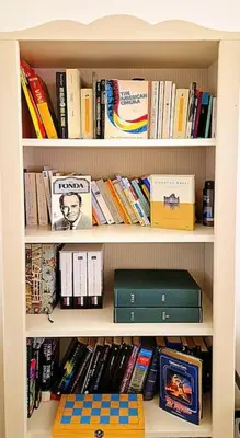 a book shelf filled with lots of books at MusicArt House in Rome
