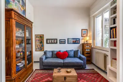 a living room with a blue couch with a red heart on it at Cozy Flat in Vatican Area with private terrace in Rome