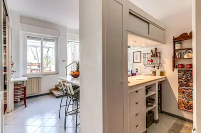 a kitchen with a counter and a table in a room at Cozy Flat in Vatican Area with private terrace in Rome