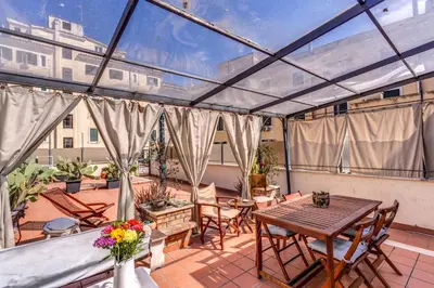 a screened in patio with a table and chairs at Cozy Flat in Vatican Area with private terrace in Rome