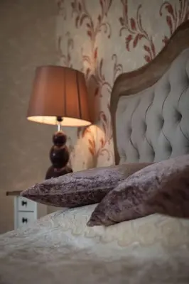 a bedroom with a bed with a lamp on it at Merulana Penthouse: 5 minutes WALK from Colosseum in Rome