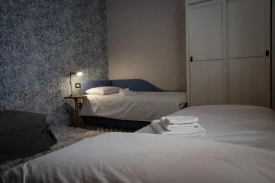 a bedroom with two beds with towels on them at Merulana Penthouse: 5 minutes WALK from Colosseum in Rome