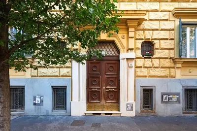 a large wooden door on the side of a building at Vatican 2BR Walk to St Peters IREX Apartment in Rome