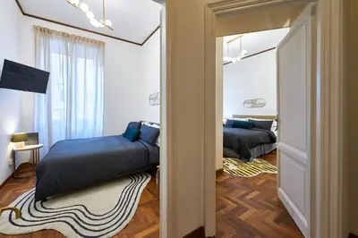 a living room with a white table and chairs at Vatican 2BR Walk to St Peters IREX Apartment in Rome