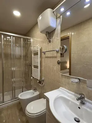 a bathroom with a toilet and a sink and a shower at Minerva House Pantheon in Rome