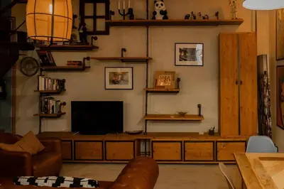 a living room with a flat screen tv on a wall at Lucky Jazz BuddyRent in Rome