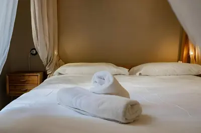a bed with two white towels on it at Lucky Jazz BuddyRent in Rome