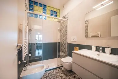 a bathroom with a sink and a toilet and a shower at St. Peter Twilight BuddyRent in Rome