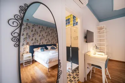 a bedroom with a bed and a mirror at St. Peter Twilight BuddyRent in Rome