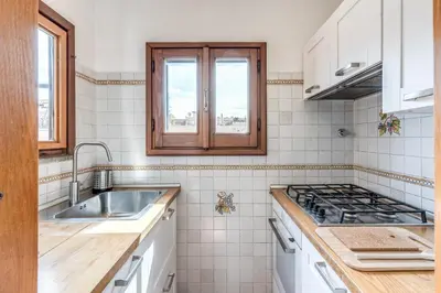 a kitchen with a sink and a stove at Twilight Terrace - Piazza di Spagna in Rome