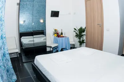 a bedroom with a bed and a table in a room at Gio' Suites in Rome