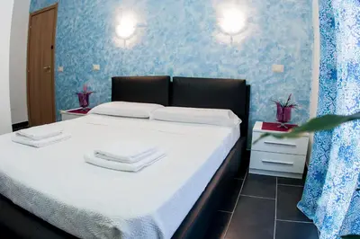 a bedroom with a bed with two towels on it at Gio' Suites in Rome