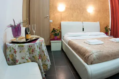 a hotel room with a bed and a table with a table sidx sidx at Gio' Suites in Rome