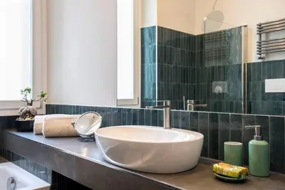 a bathroom with a large white bowl sink on a counter at Testaccio Boutique Apartment in Rome