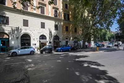 two cars parked on a street in front of a building at Testaccio Boutique Apartment in Rome