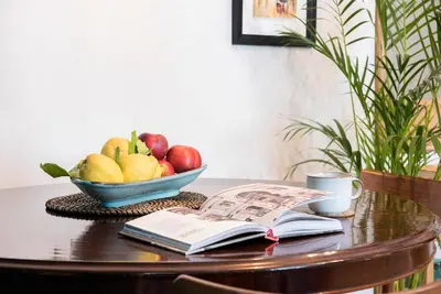 a bowl of fruit and a book on a table at Testaccio Boutique Apartment in Rome