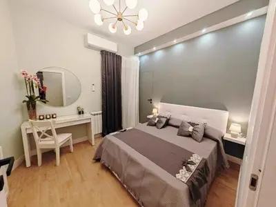 a bedroom with a bed and a desk and a mirror at Domus Aldini in Rome