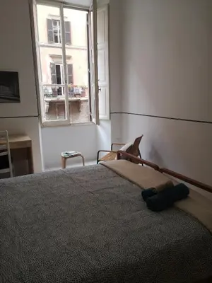 a bedroom with a large bed with a window at Romeo. Luminoso appartamento al centro di Roma in Rome
