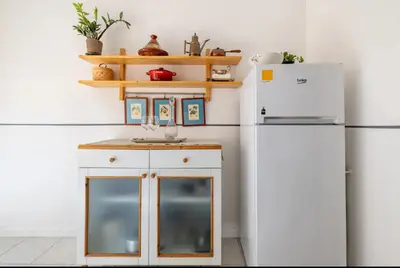 a kitchen with a sink and a refrigerator at Romeo. Luminoso appartamento al centro di Roma in Rome