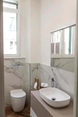 a white bathroom with a sink and a toilet at Casa Matteo53, Termini in Rome