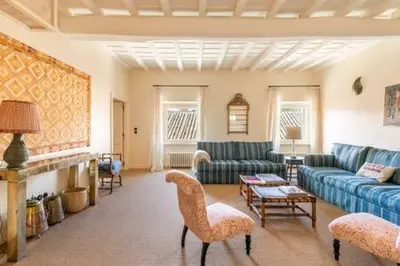 a living room with a blue couch and chairs at Trastevere Luxury Home in Rome
