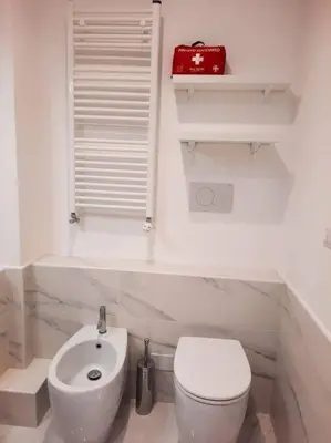 a white bathroom with a toilet and a sink at RomAntica Lemon Apartment in San Giovanni in Rome