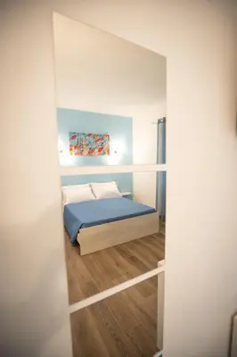 a small bedroom with a bed in a room at ROMECOMING Ostiense Guest House in Rome