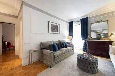 a living room with a couch and a mirror at Germanico Charming Maison in Rome